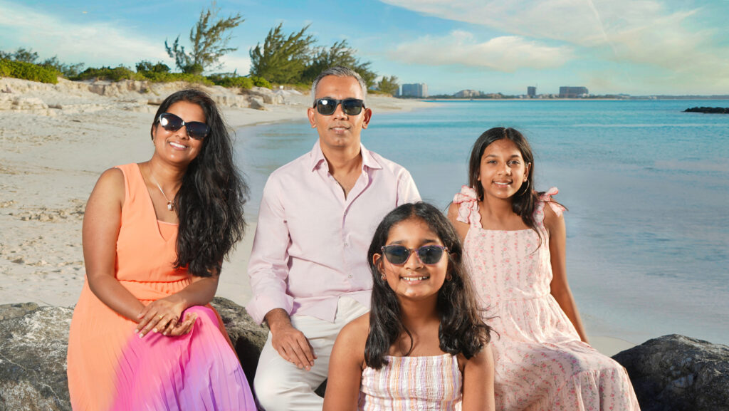 Home Turks and Caicos family photographer capturing a family portrait on the beach